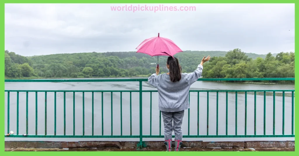 A woman seen from behind standing by a green railing on a rainy day, holding a pink umbrella over a body of water.