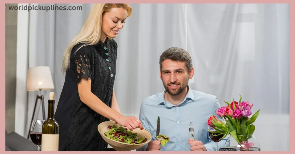 A smiling blonde woman serving salad to a seated man during a meal at home.