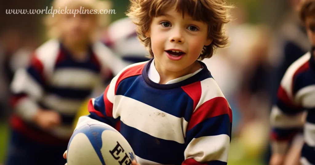A young boy wearing a striped red, white, and blue rugby jersey smiles while holding a rugby ball outdoors.